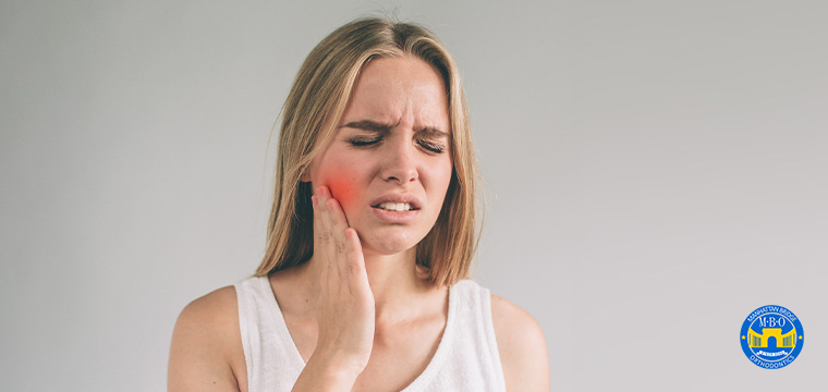 Manhattan Bridge Orthodontics Girl with Jaw Pain holding her swollen red cheek