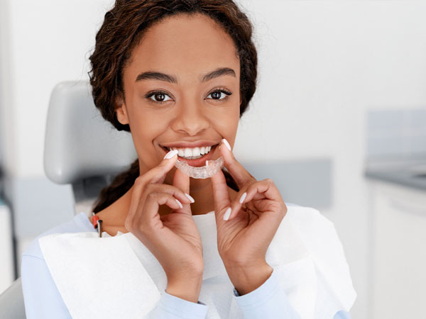 Manhattan Bridge Orthodontics girl putting on her aligner