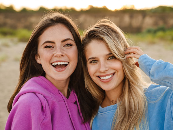 Manhattan Bridge Orthodontics two friends with nice teeth smiling for photo