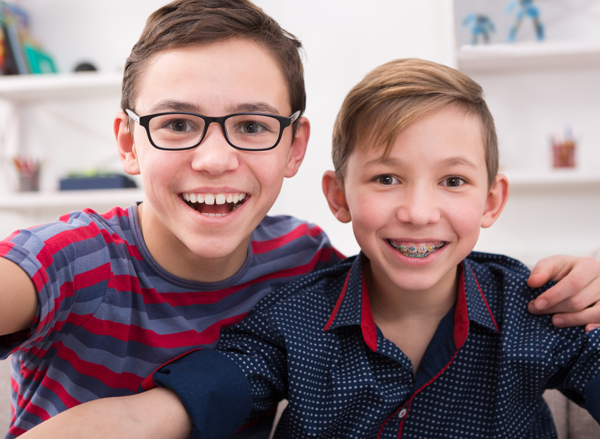 Manhattan Bridge Orthodontics Two boys smiling at camera with braces